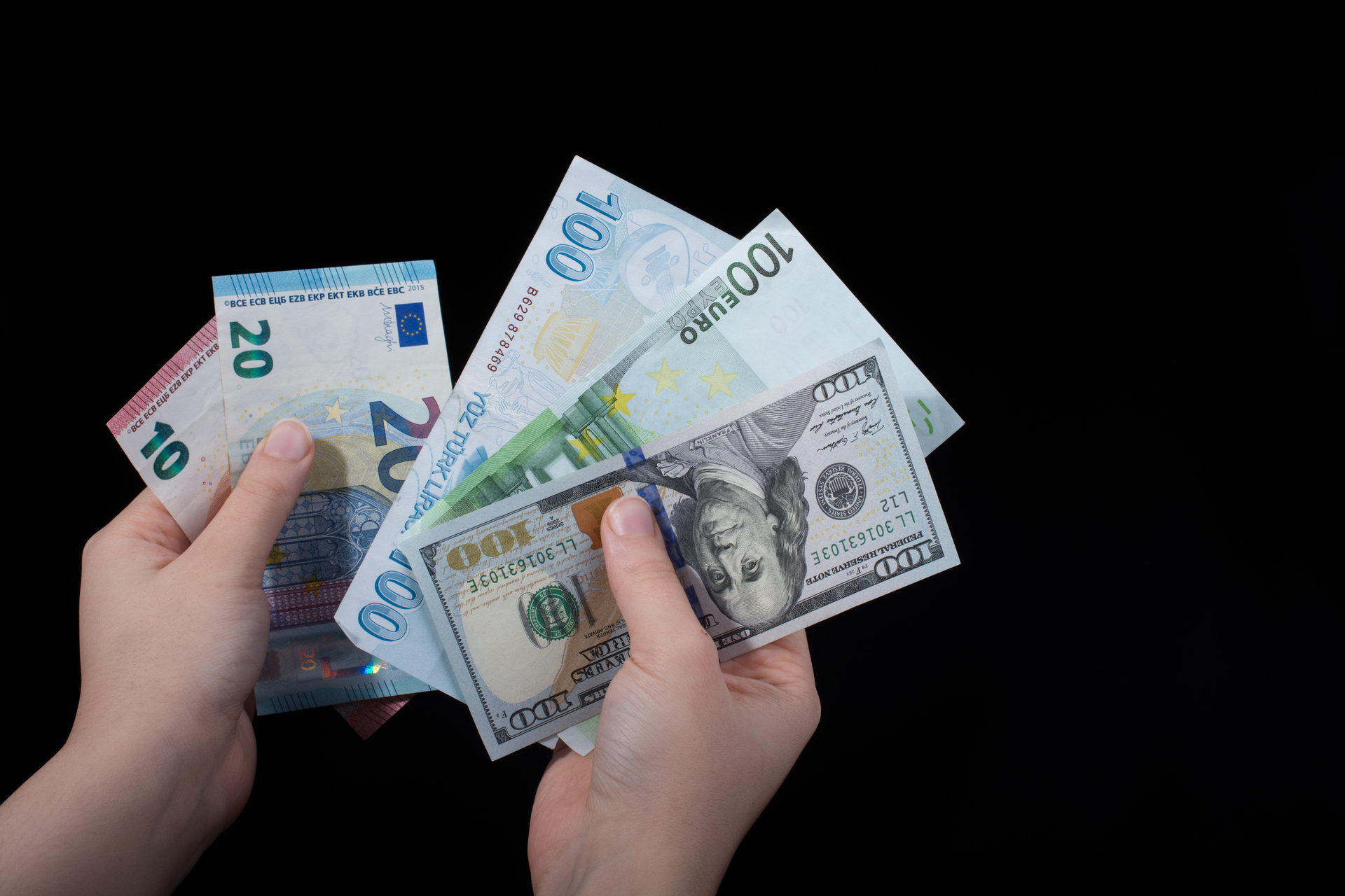 Banknoty w dłoniach, na czarnym tle, które symbolizują PKB Turcji